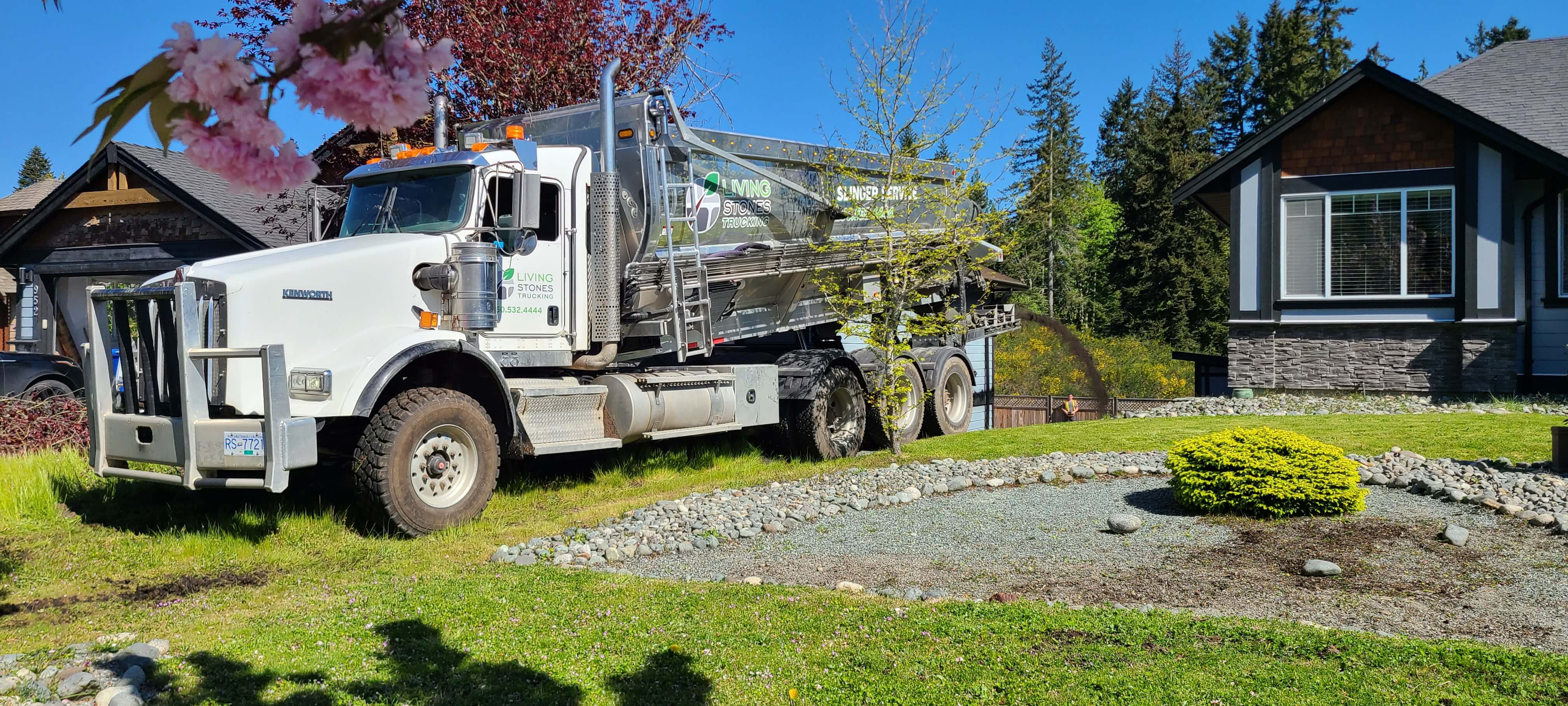 pictured is a picture of one of the slinger trucks used by Benchmark Trucking, in the front yard of customer